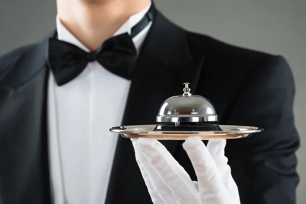 Luxury concierge service with bellhop tray.