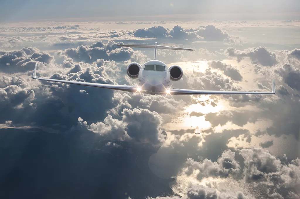 Private Jet Flying over clouds
