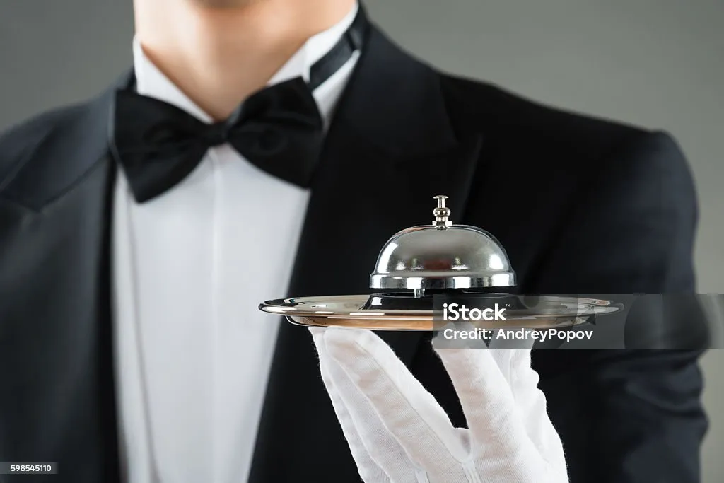 Luxury concierge service with bellhop tray.
